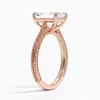 Perspective angled view of a 3 carat emerald cut lab diamond ring with vintage carved pattern in rose gold.