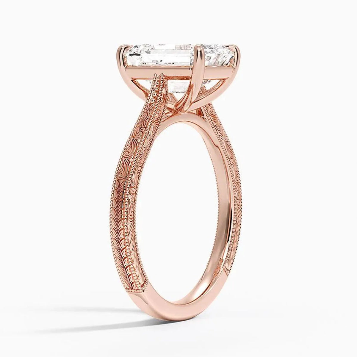 Perspective angled view of a 3 carat emerald cut lab diamond ring with vintage carved pattern in rose gold.