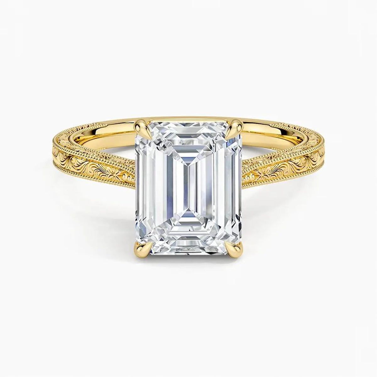 Direct top-down view of a 3 CT emerald cut lab grown diamond engagement ring with vintage carved shoulders in yellow gold.