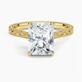 Direct top-down view of a 3 CT radiant cut lab grown diamond engagement ring on an engraved yellow gold band.
