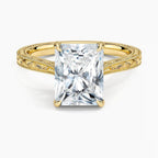 Direct top-down view of a 3 CT radiant cut lab grown diamond engagement ring on an engraved yellow gold band.