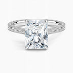 Direct top-down view displaying a 3 CT radiant cut lab diamond set in 4 prongs on a white gold engraved band.
