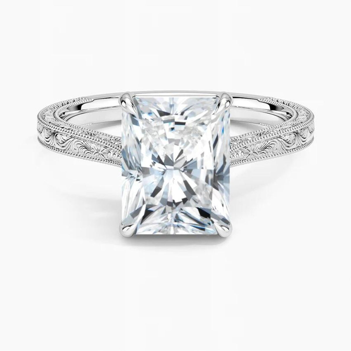 Direct top-down view displaying a 3 CT radiant cut lab diamond set in 4 prongs on a white gold engraved band.