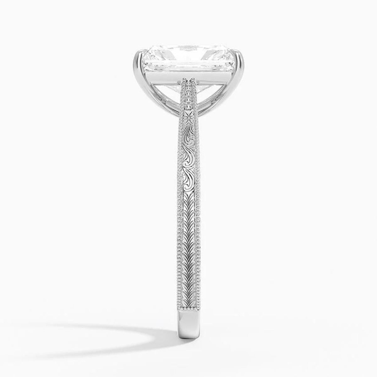 Side profile view of a 3 CT radiant cut lab diamond ring with carved scrollwork and milgrain borders in white gold.