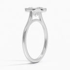 Angled side profile showing smooth white gold band and cathedral support under the milgrain bezel setting.