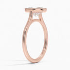 Angled side view of a 3 carat oval lab grown diamond engagement ring in rose gold with milgrain frame.