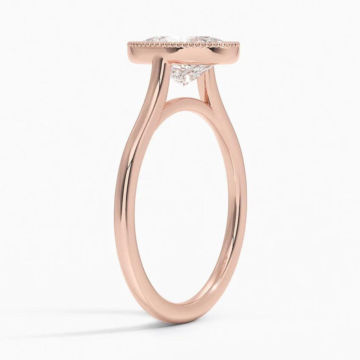 Angled side view of a 3 carat oval lab grown diamond engagement ring in rose gold with milgrain frame.