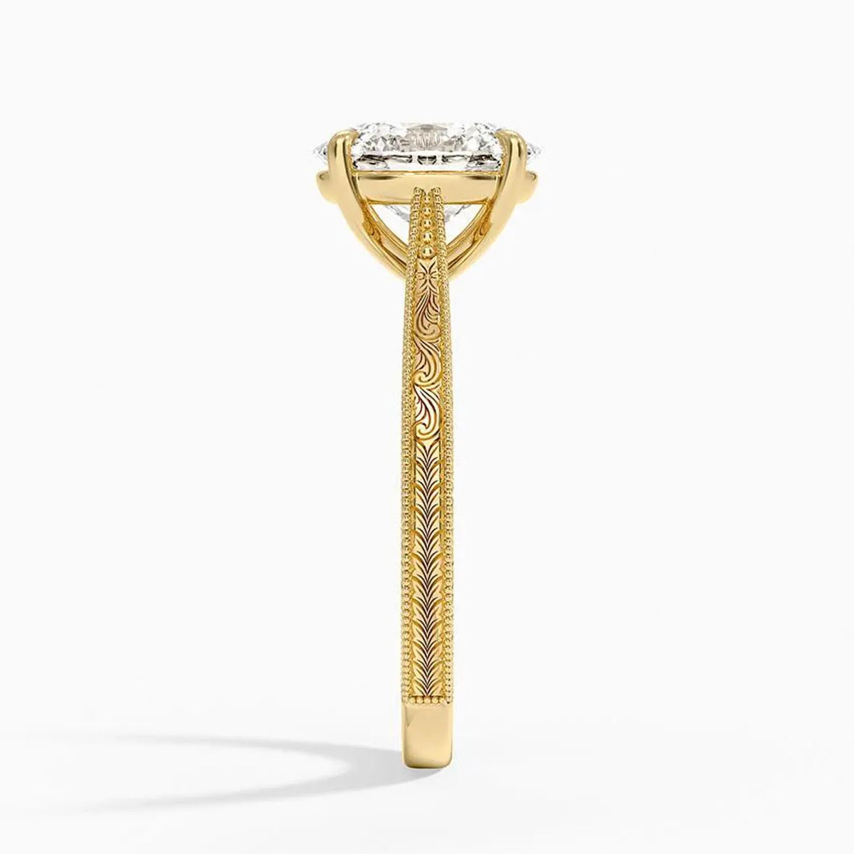 Side profile view showing hand-carved vintage scrollwork patterns on a yellow gold engagement ring.