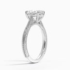 Perspective angled view of a 3 CT oval cut lab diamond engagement ring with carved scrollwork in white gold.