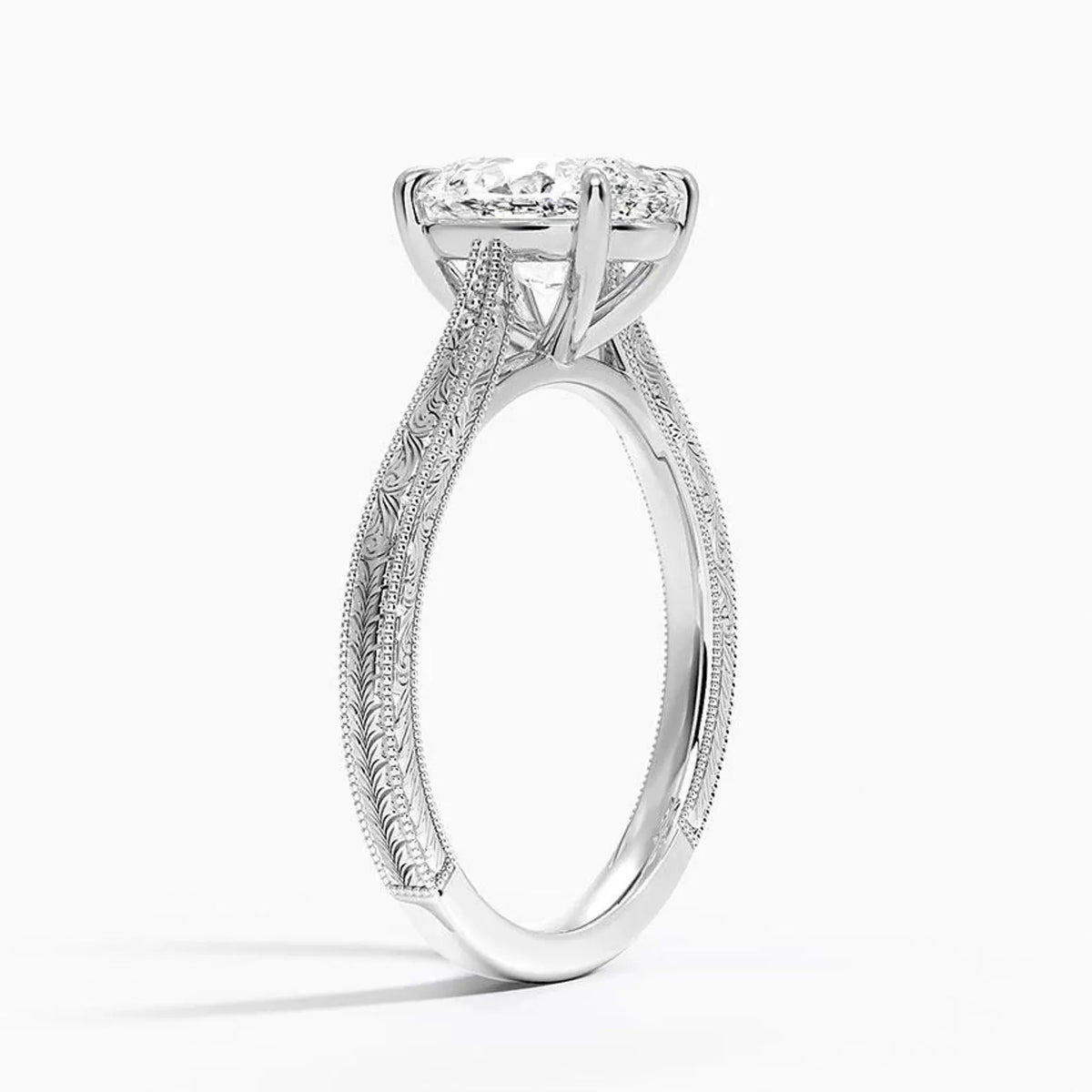 Perspective angled view of a 3 CT oval cut lab diamond engagement ring with carved scrollwork in white gold.