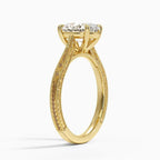 Perspective angled view of a 3 carat oval cut lab grown diamond engagement ring with hand engraving in yellow gold.