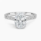 Direct top perspective view displaying a 3 CT oval cut lab diamond set in 4 prongs on a white gold engraved band.