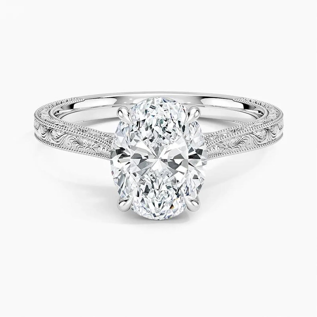 Direct top perspective view displaying a 3 CT oval cut lab diamond set in 4 prongs on a white gold engraved band.