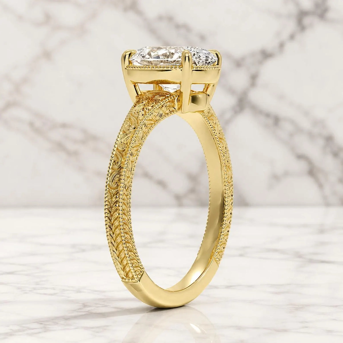 Angled view displaying the hand-engraved scrollwork details and inner polished yellow gold band of an oval diamond ring.   