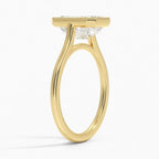 Three-quarter profile view of a 4 CT emerald cut lab diamond ring featuring a milgrain collar on a yellow gold band.