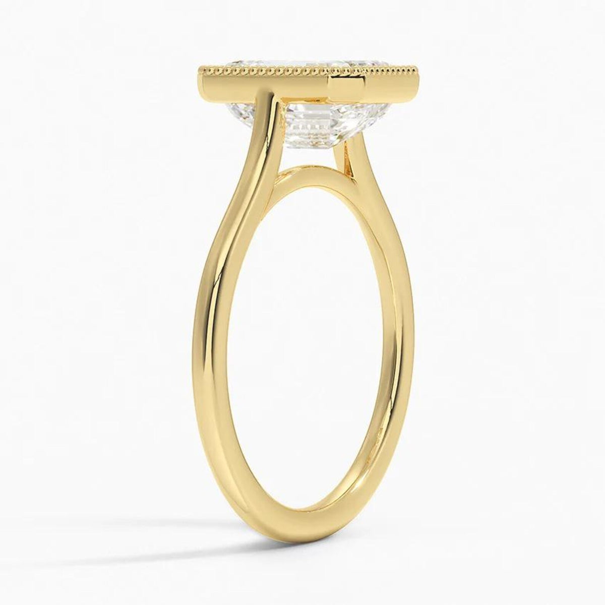 Three-quarter profile view of a 4 CT emerald cut lab diamond ring featuring a milgrain collar on a yellow gold band.