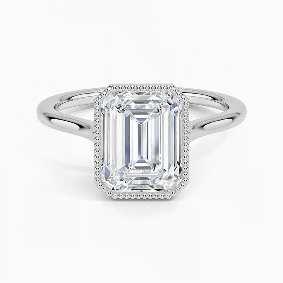 Top-down direct view of a 4 CT emerald cut lab grown diamond ring framed by delicate milgrain in white gold.