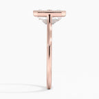 Direct side profile view showing the slender rose gold band and milgrain frame setting of an emerald cut diamond ring.