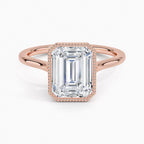 Direct top view of a 4 CT emerald cut lab grown diamond engagement ring set in a rose gold milgrain frame.