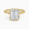 Direct top view of a 4 CT emerald cut lab diamond solitaire ring with a milgrain bezel in yellow gold.
