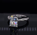 Direct front view of a 3 CT radiant cut lab grown diamond engagement ring featuring a white gold twisted micro-pavé band.