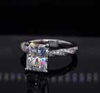 Direct front view of a 3 CT radiant cut lab grown diamond engagement ring featuring a white gold twisted micro-pavé band.