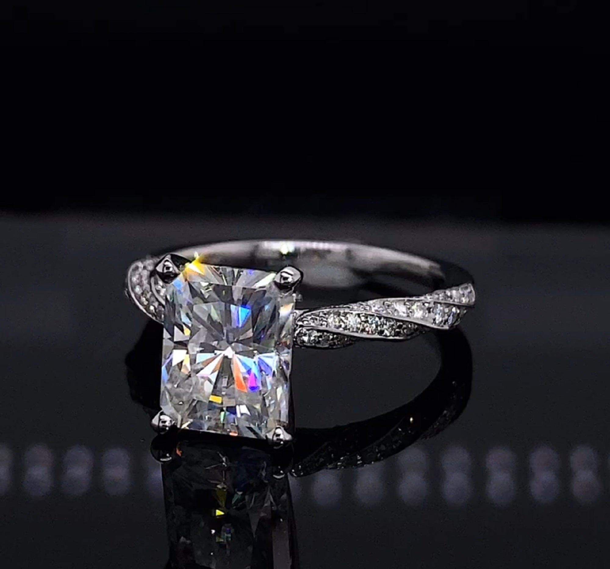 Direct front view of a 3 CT radiant cut lab grown diamond engagement ring featuring a white gold twisted micro-pavé band.