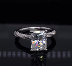 Straight-on view showing the fiery brilliance of a 3 carat elongated radiant lab diamond on a braided diamond-encrusted band.