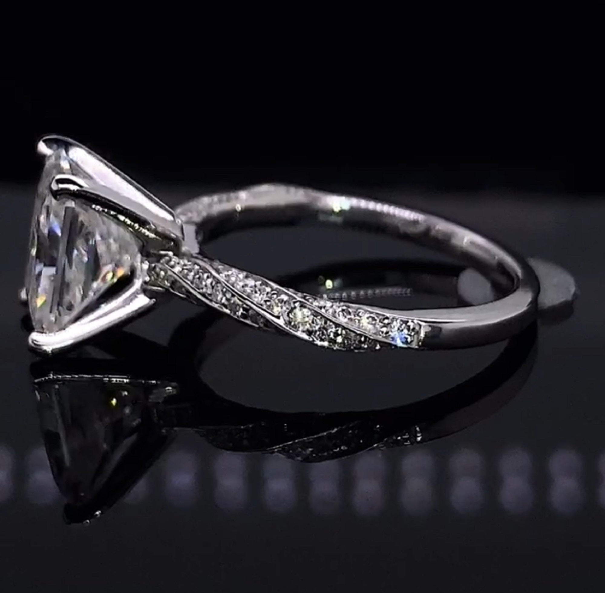 Detailed side view illustrating the twisted band profile and polished lower shank of the 3 CT radiant solitaire ring.