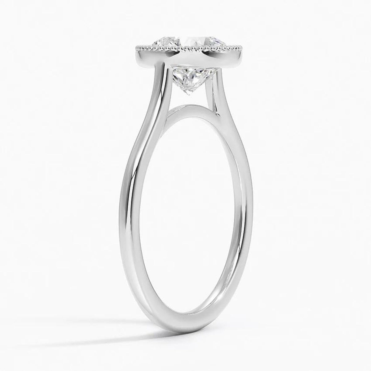 Side angle view of a 3 CT round lab grown diamond engagement ring in white gold showing a milgrain bezel rim and cathedral band.