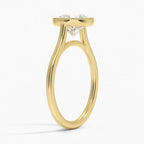 Angled profile view of a yellow gold 3 CT round lab diamond engagement ring featuring a milgrain bezel rim.   