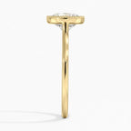 Direct side profile view of a thin yellow gold cathedral band holding a 3 CT round brilliant lab diamond in a milgrain bezel setting.