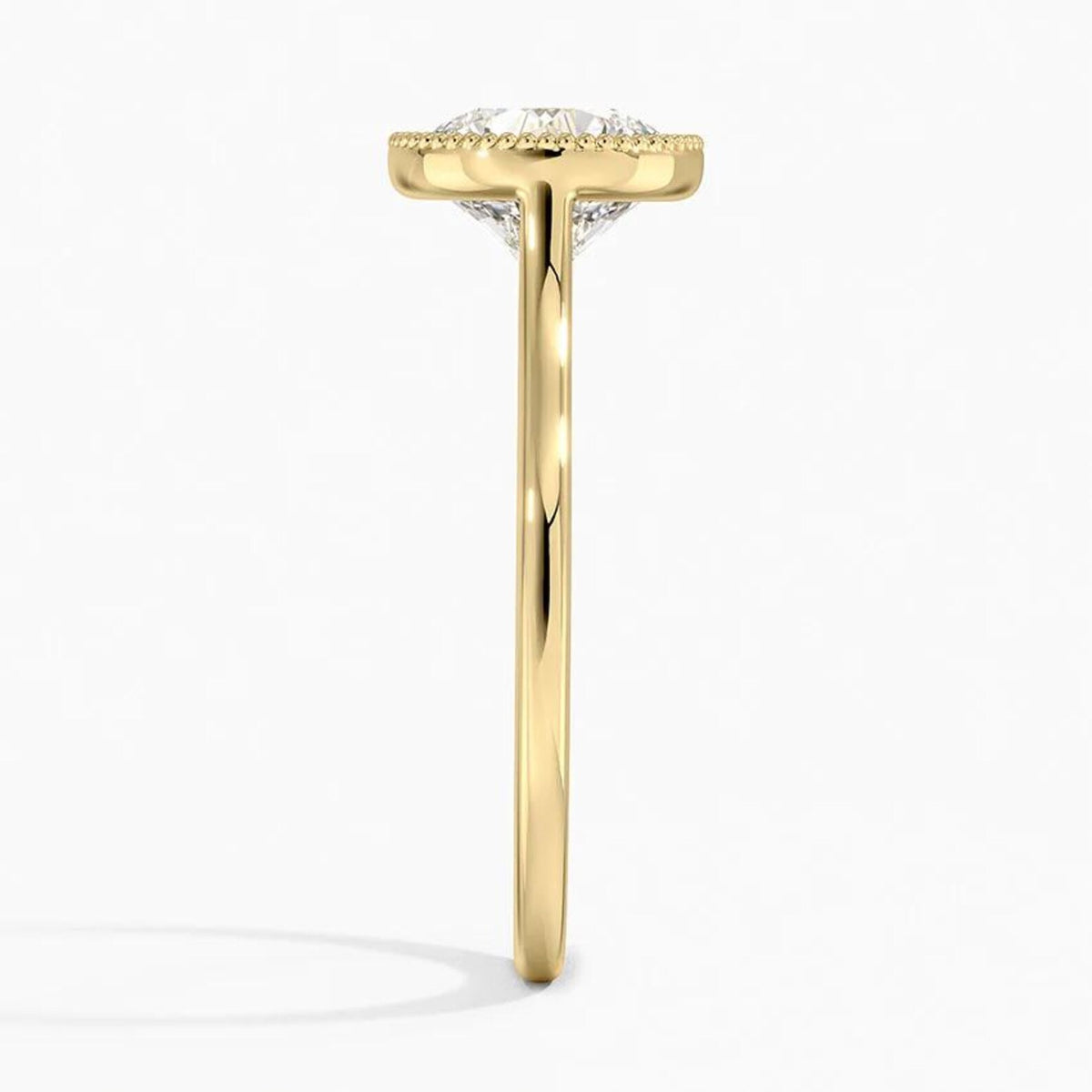 Direct side profile view of a thin yellow gold cathedral band holding a 3 CT round brilliant lab diamond in a milgrain bezel setting.