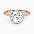 Top-down view showcasing a 3 CT round brilliant lab grown diamond in a rose gold milgrain bezel setting.