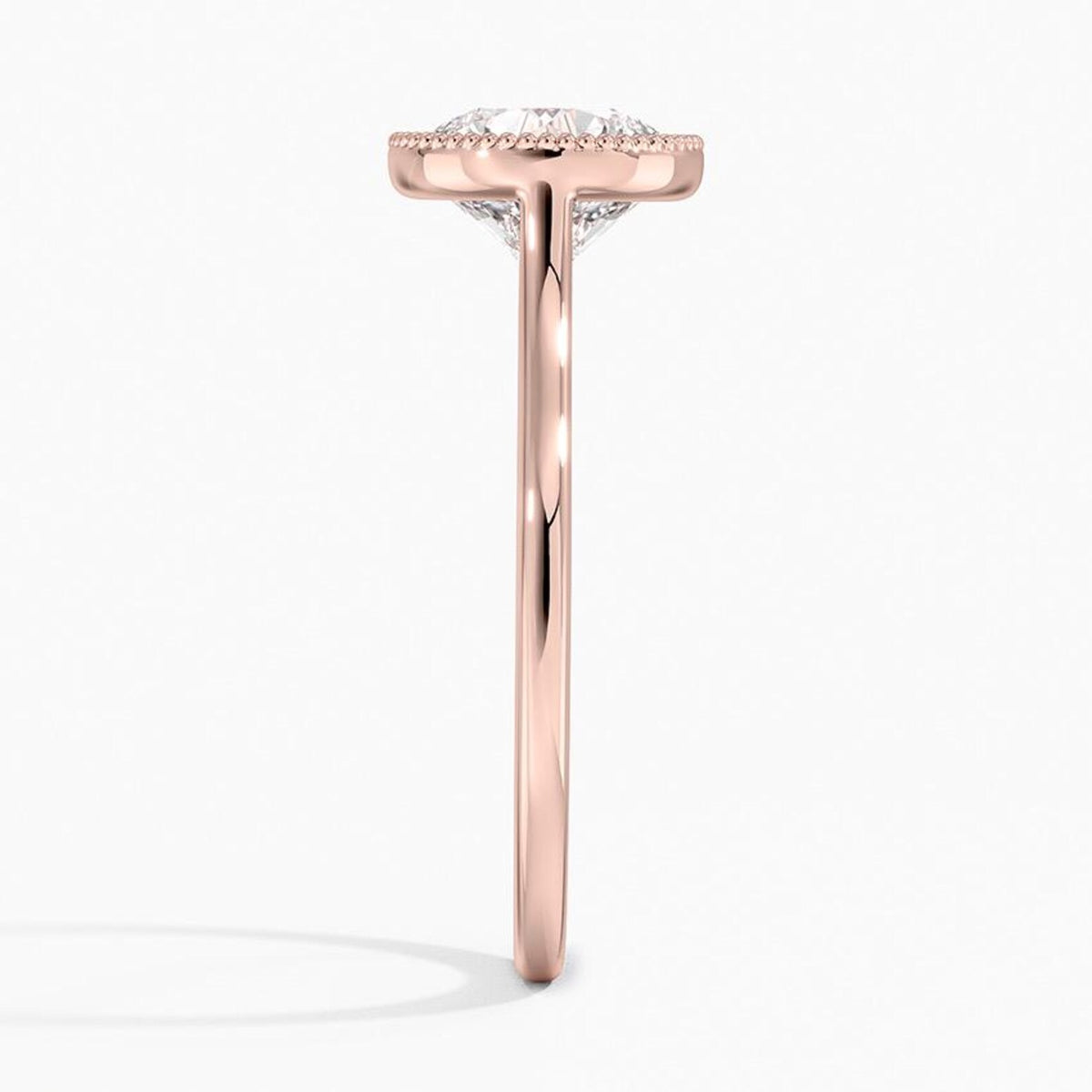 Direct side profile view of a 3 CT round lab diamond engagement ring in polished rose gold.