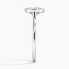 Direct side profile view of a polished white gold ring band with a milgrain bezel setting holding a round lab diamond