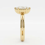 Side profile view displaying the fluted scalloped setting and split double band of a yellow gold oval engagement ring.