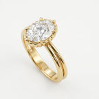 Angled view showcasing a 3 CT oval cut lab grown diamond set on a yellow gold double-wire band with a scalloped crown basket.