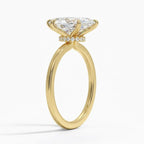 Side profile view of a 4 CT marquise lab grown diamond engagement ring in yellow gold with a diamond hidden halo