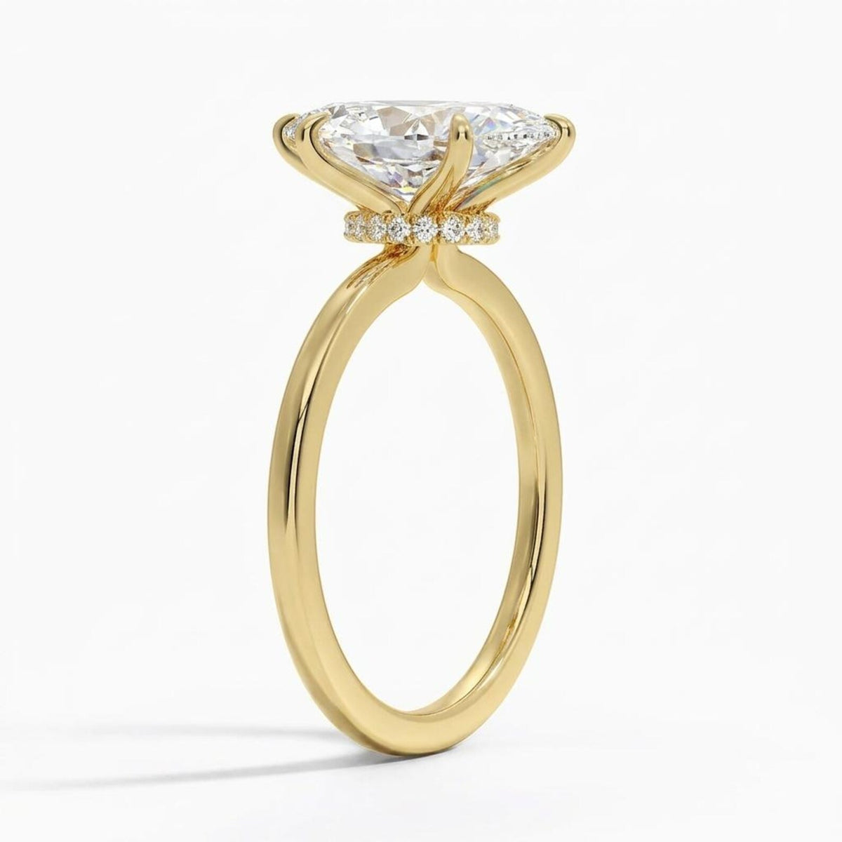 Side profile view of a 4 CT marquise lab grown diamond engagement ring in yellow gold with a diamond hidden halo