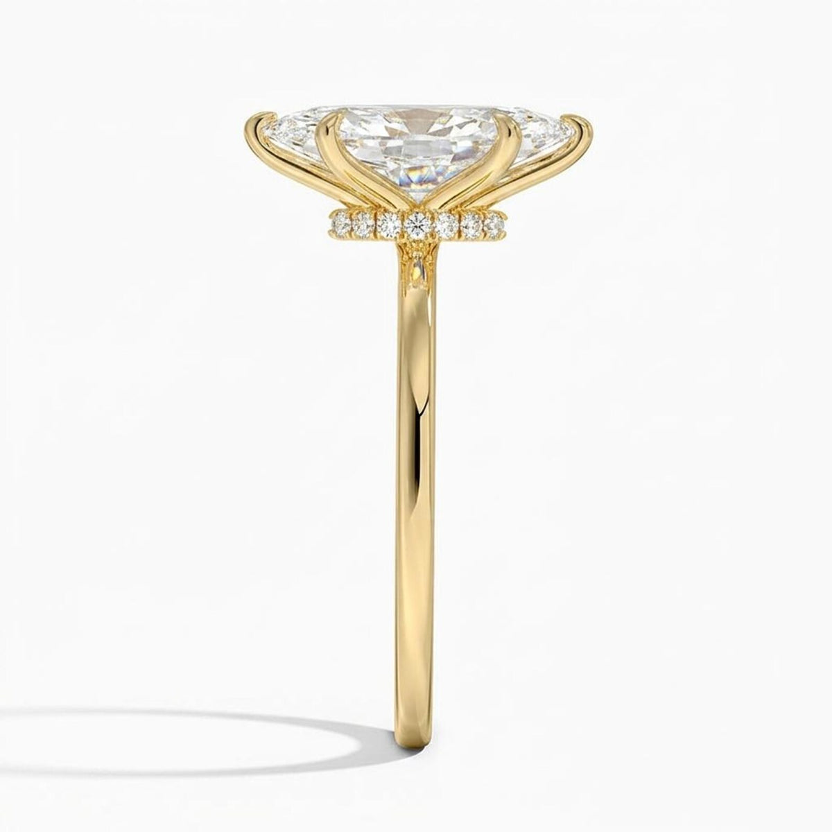 Direct side view showing the thin yellow gold band and pavé diamond hidden halo under a 4 CT marquise cut lab diamond