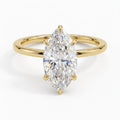 Direct top-down view of a 4 CT marquise cut lab grown diamond solitaire ring with 6 claw prongs on a yellow gold band.