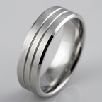 Close-up studio view of a men's white gold wedding band with double parallel channel grooves, a brushed center finish, and shiny beveled edges