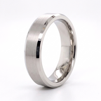 Angled studio view of a men's white gold wedding band with brushed center and polished beveled edges