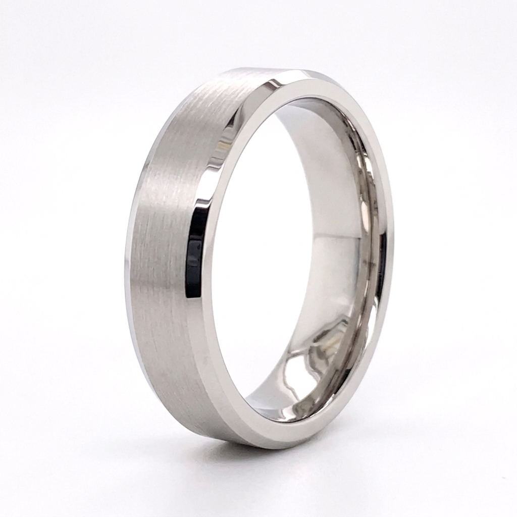 Angled studio view of a men's white gold wedding band with brushed center and polished beveled edges