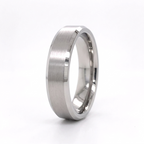 Vertical angled view of a men's white gold brushed wedding ring with mirror-polished bevels