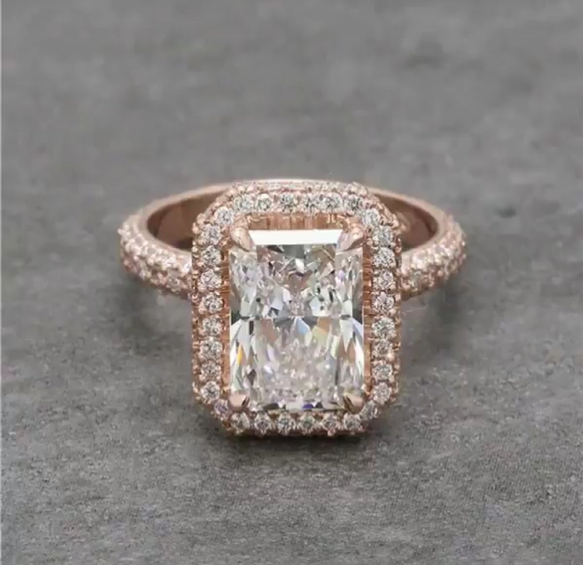 Direct top view of a 4 CT radiant cut lab grown diamond halo engagement ring in rose gold with a multi-row pavé band.