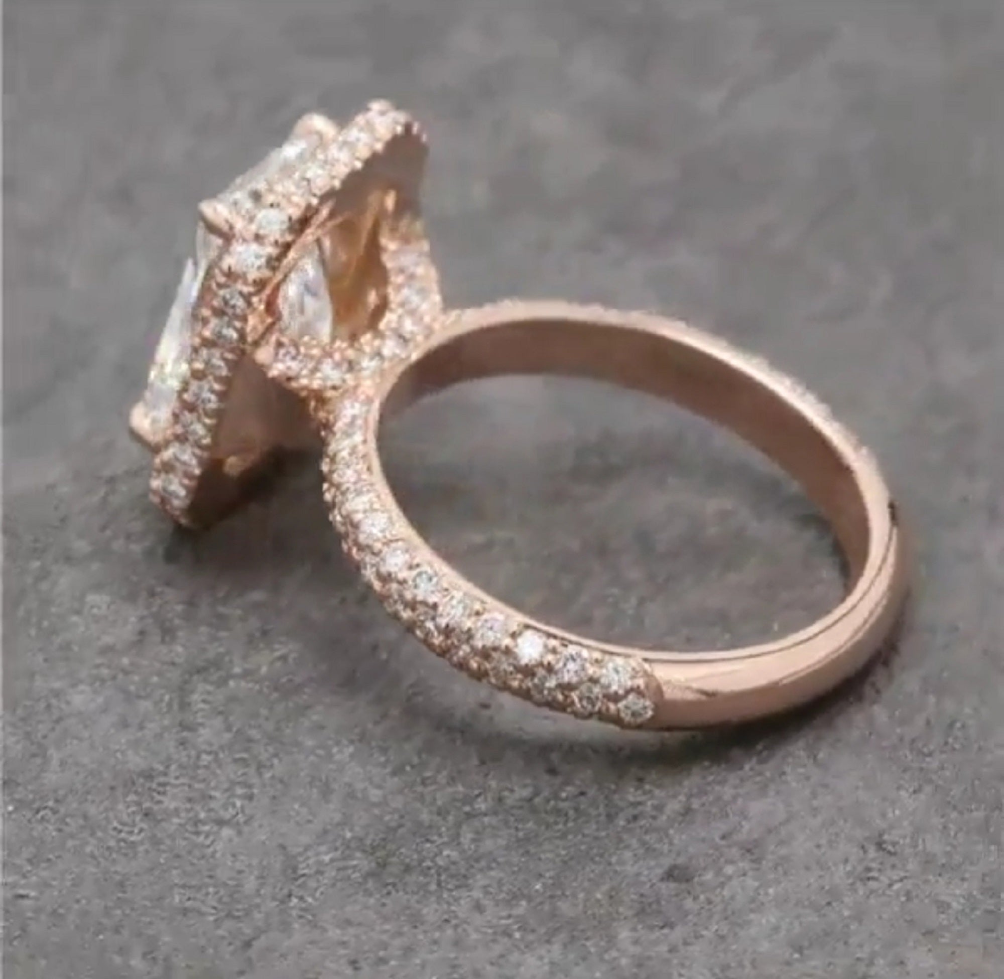 High-profile side view detailing the rose gold halo gallery architecture and shimmering triple-row pavé shank.