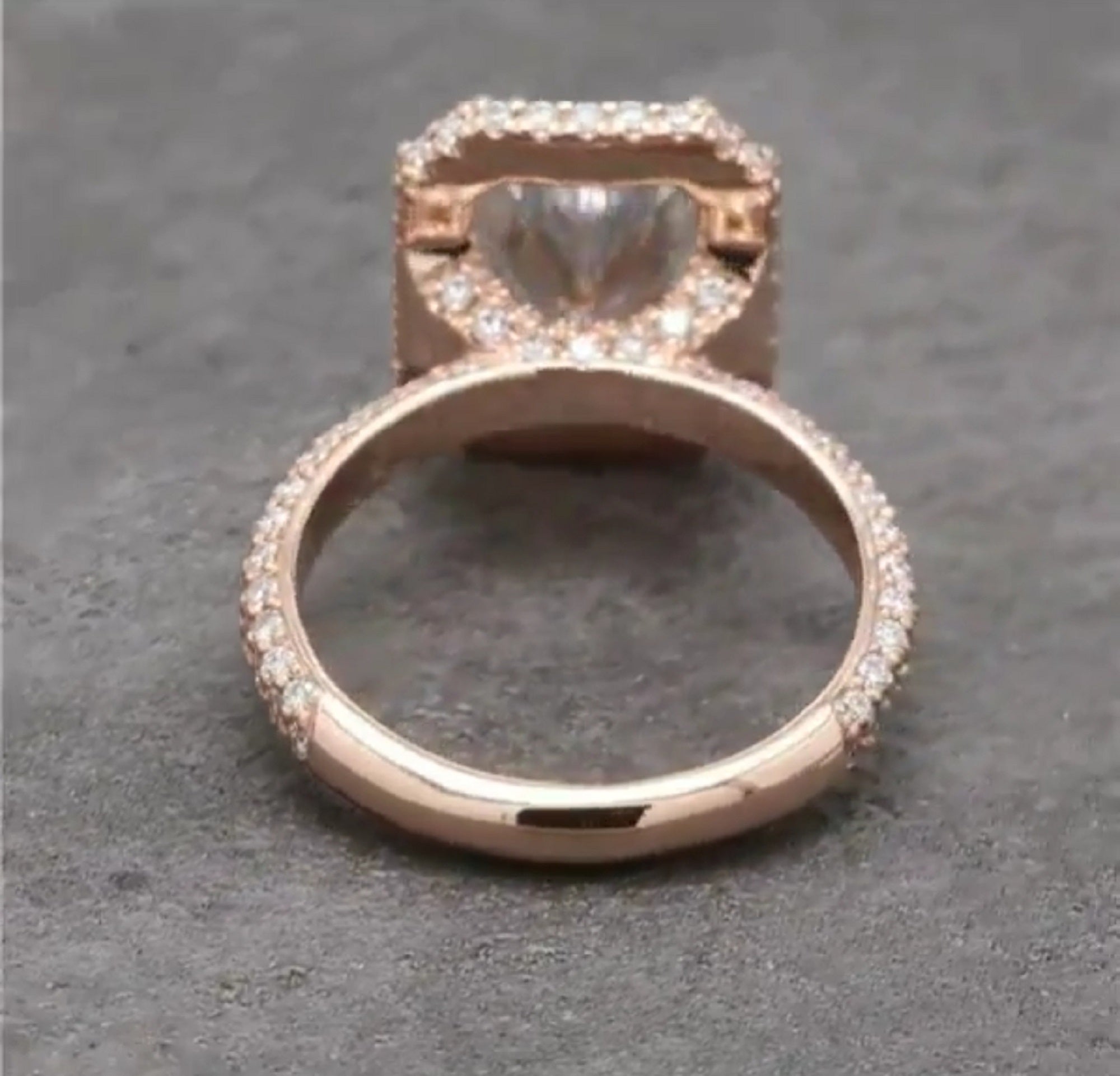 Under-gallery rear shot revealing the open setting basket design and smooth rose gold bottom band.