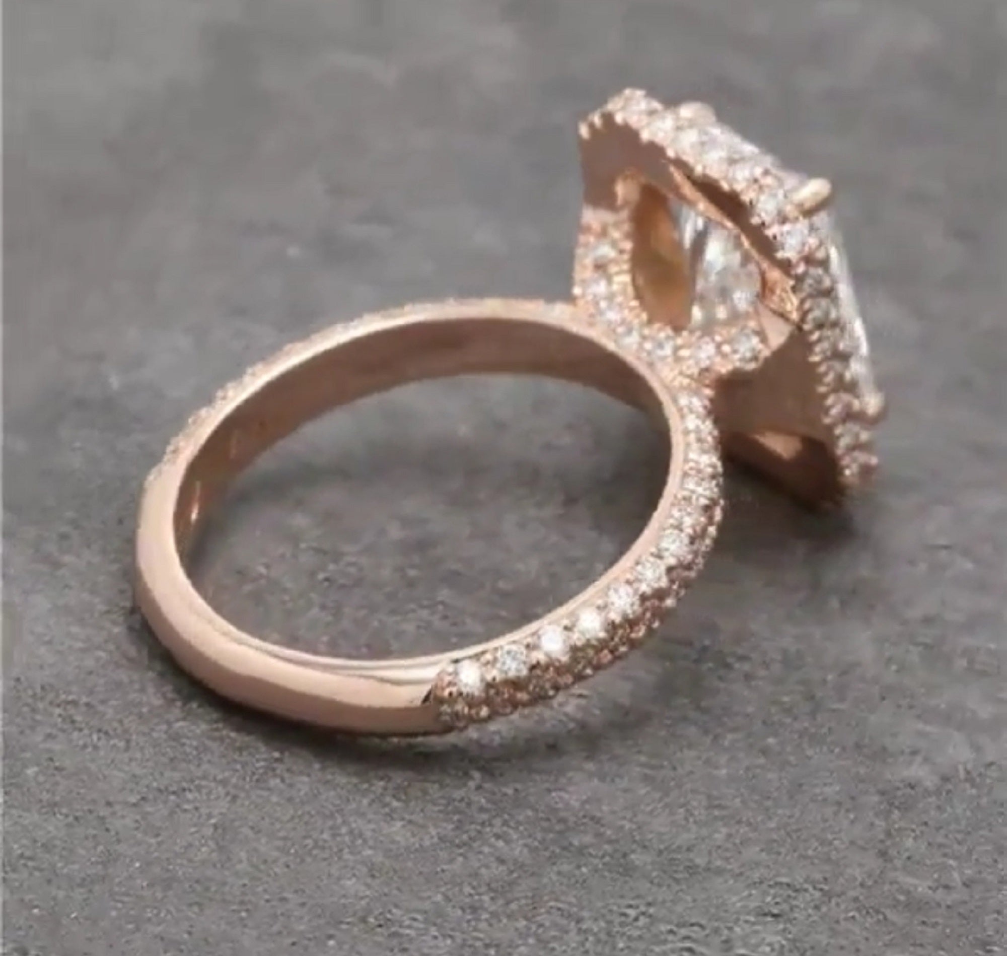 Side profile view emphasizing the thick multi-row micro-pavé diamond band extending down the rose gold ring shank.